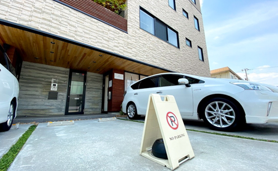 アクセス04:駐車場は、玄関前の駐車場をご利用ください。白い駐車禁止の札は移動してください。